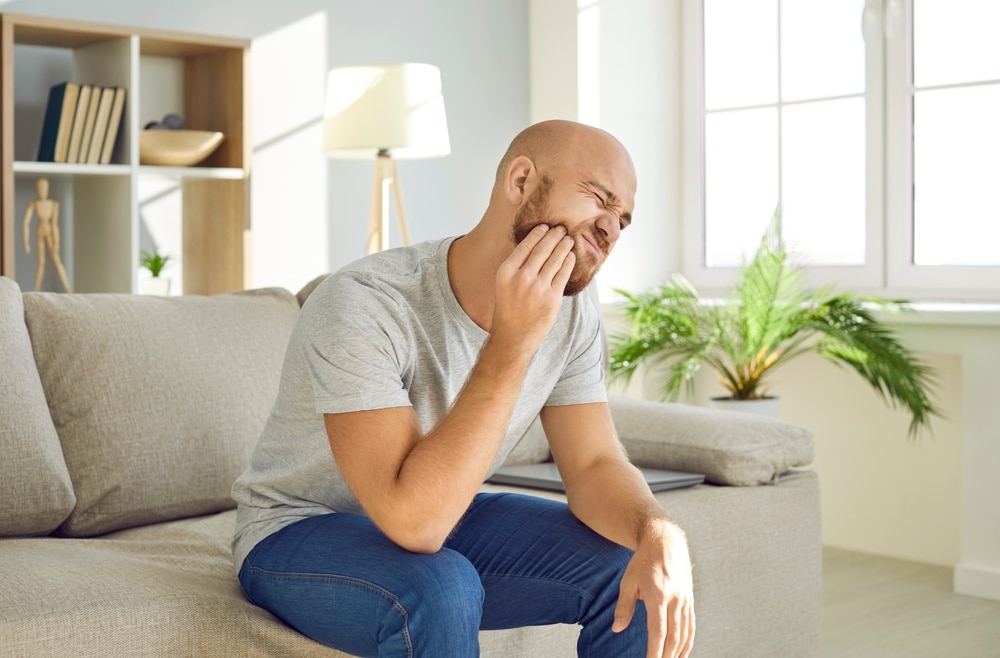Patient experiencing dental pain at home